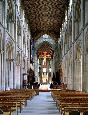 The nave of Peterborough Cathedral is in three stages supporting a rare wooden ceiling retaining its original decoration.