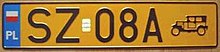 Yellow orange plate reading SZ08A. A vintage car symbol is visible next to the number. Polish national flag is in the top-left corner