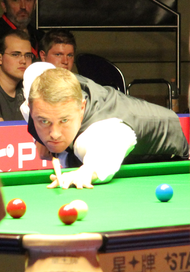 Stephen Hendry ready to play a shot on a red ball