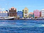 Port with colorful houses in blue, brown, green, yellow, pink.