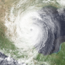 Satellite image of a tropical cyclone in the Western Gulf of Mexico. It covers a large area and has an eye at center.