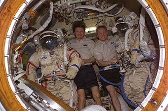 Gennady Padalka (left) and astronaut Michael Fincke pose with their Orlan spacesuits.