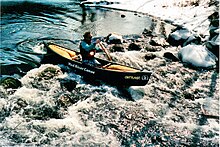 A canoeist on the Ramapo River, New York State, USA.