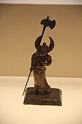Northern Song figurine of a deity wearing cord and plaque, mountain pattern armour, wielding a large axe