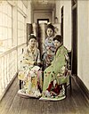 Three Maiko posing on an engawa, c. 1885. Hand-coloured albumen silver print.