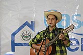 Young Salvadoran man playing a guitar