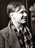 A black and white photograph of gay author Christopher Isherwood at a train station