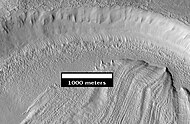 Concentric Crater Fill Close-up of near the top of previous image, as seen by HiRISE. The surface debris covers water ice.