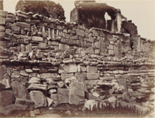 Photograph of a wall haphazardly made from stone and marble antiquities.