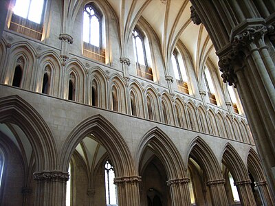The three levels of the nave (1192–1230) of Wells Cathedral, the first in England to use pointed arches exclusively in the ceiling vaults, the windows of the clerestory and arcades of the triforium, and the arcades on the ground floor