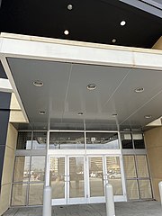A bordered up former Sears store entrance.