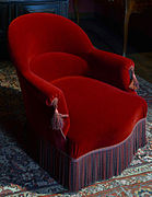 A crapaud armchair with fringe hiding the legs, from the apartment of Victor Hugo