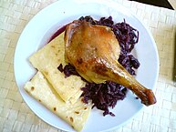 Roasted duck leg with greasy lokše and stewed red cabbage