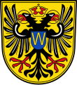 Große Kreisstadt Donauwörth In Gold ein rot bewehrter Doppeladler, zwischen den nimbierten Köpfen eine goldene Kaiserkrone; im blauen Brustschild der goldene Großbuchstabe W.