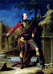 Man in a classical-inspired pose, wearing a military doublet and a kilt in a tartan with more of a striped than checked look