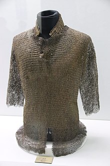 Torso-covering mail armour on a black mannequin