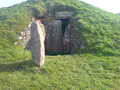 South-west side. A replica of the decorated stone stands outside the south-west opening in the burial chamber.