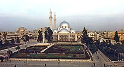 A religious building with multiple silver domes