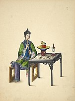 Woman playing a xiao.