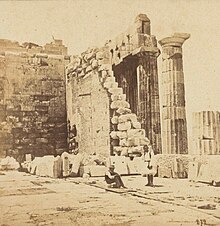 Albumen photograph of Greek ruins, with two men in the foreground.