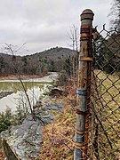 Portrait photograph showing the edge of a lake and a fence, at Yellow Creek Lake in Indiana County, Pennsylvania