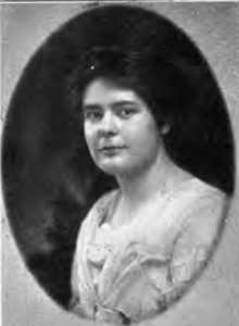 A young white woman with dark hair, in an oval frame