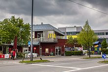 Outside the McDonald's on Hanauer Straße 83, looking northwest on a cloudy day.
