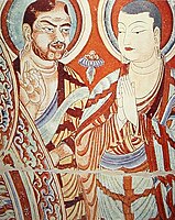A blue-eyed Central Asian monk teaching an East-Asian monk, Bezeklik, Turfan, eastern Tarim Basin, China, 9th century; the monk on the right is possibly Tocharian,[127] although more likely Sogdian.[128][129]
