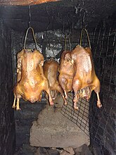 Geese being smoked in a smokehouse