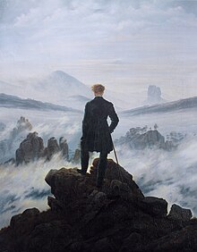 Painting of a man standing with his back to the viewer. He is atop a mountain and surrounded by clouds and fog. He is dressed in black and contrasts sharply with the whites, pinks, and blues of the atmosphere. In the distance outcroppings of rocks can be seen.