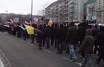 Warmly-dressed marchers with flags