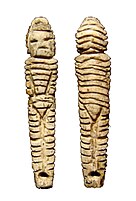 Statuette with hooded, decorated, overall.[11]