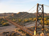 The McPhaul Suspension Bridge on a former section of US Route 95 spans the Gila between the Gila and Laguna ranges in Yuma County. The bridge is listed on the National Register of Historic Places.