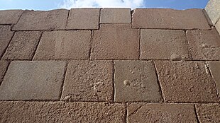 Wall of irregular stone blocks