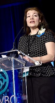 Amanda Matthews at the NAWBO Kentucky Chapter 2018 Awards at a podium accepting Strive Business Owner of the Year Award, mid-speech.