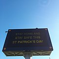 Electronic traffic sign, ahead of Saint Patrick's Day 2021, urging people to stay at home during the COVID-19 lockdown.