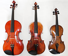 A modern tenor violin next to a standard viola and violin.