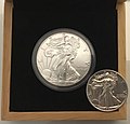 Image 11An American Silver Eagle minted in 2019 (left), an example of a Bullion coin. Its obverse design is based on the older, formerly circulating silver Walking Liberty half dollar (right). (from Coin)