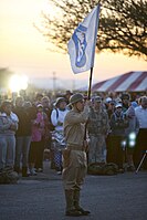 A U.S. Army member posts the flag of the "Battling Bastards of Bataan" at the opening ceremony of the Bataan Memorial Death March.