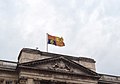 The Royal Standard of the United Kingdom used outside of Scotland, featuring the Royal Banner of Scotland in the second quarter, flying over Buckingham Palace, London.
