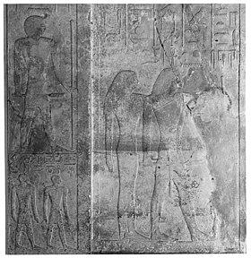 Relief with a man and a woman standing, surrounded by hieroglyphs