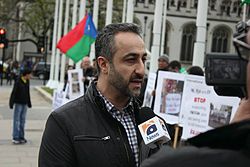 Hyrbyair Marri speaking to media in London during a protest.