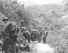 Soldiers that are part of Merrill's Marauders, resting alongside a jungle trail in Burma