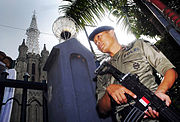 A Brimob personnel with a Pindad SS1 rifle guarding the Jakarta Cathedral.