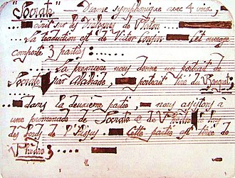 neatly written manuscript of musical score, with careful, calligraphic letters in red ink