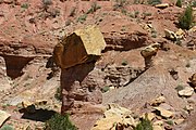 An ancient rockfall which protected the rock records beneath its impact site from further large scale erosion. Taken along Burr Trail, Grand Staircase–Escalante National Monument, Utah, US.