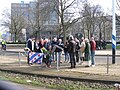 Family and friends attach flowers for a Frisian victim to the tram track fence.