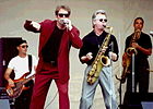 Members of the band Huey Lewis and the News performing in concert