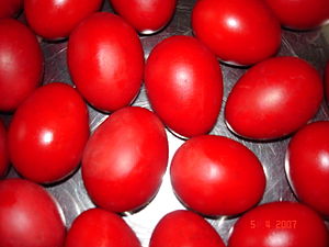 Traditional red Easter eggs for blessing by a priest