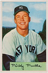 "Baseball card of a young, clean-shaven man in New York Yankees grey uniforms and cap smiling straight ahead."